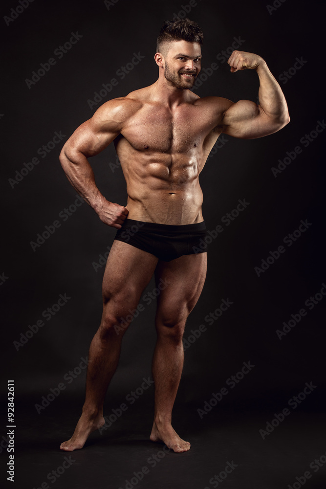 Fototapeta premium Strong Athletic Man Fitness Model Torso showing big muscles