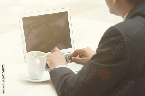 Fototapeta Naklejka Na Ścianę i Meble -  business man using laptop with coffee in the morning