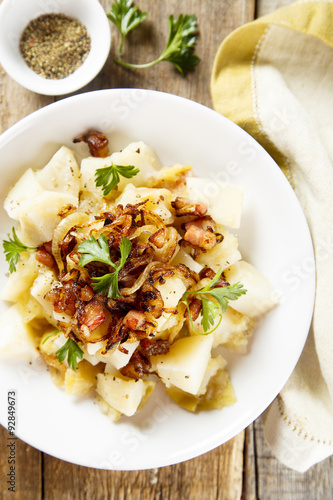 Potato salad with apples, fried onion and ham