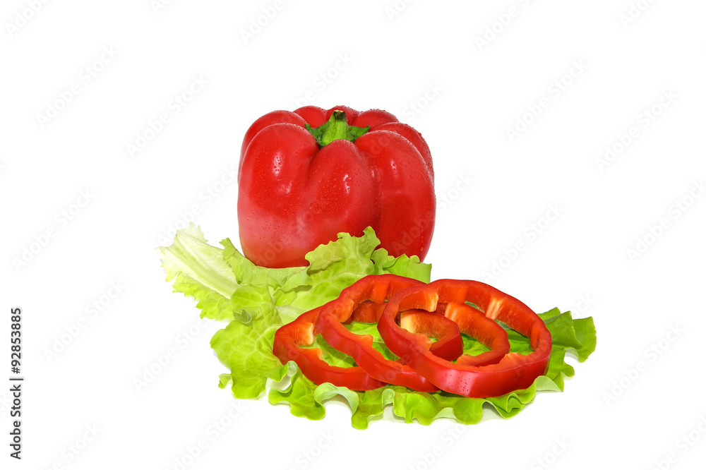 Petite red pepper and slices on a green leaf lettuce. Water drops on peppers. Juicy slices of pepper and fresh green salad leaf. Close-up. Petite red pepper and slices on a green leaf lettuce. Water drops on peppers. Juicy slices of pepper and fresh green salad leaf. Close-up.