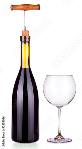 Elegant red wine glass and bottle isolated