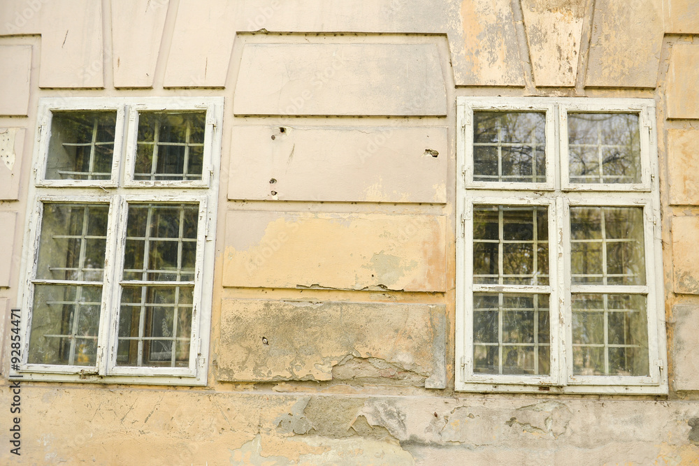 Old damaged wall of a castle with windows