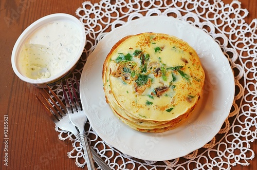 Pancakes with herbs and mushrooms and scrambled eggs for breakfast