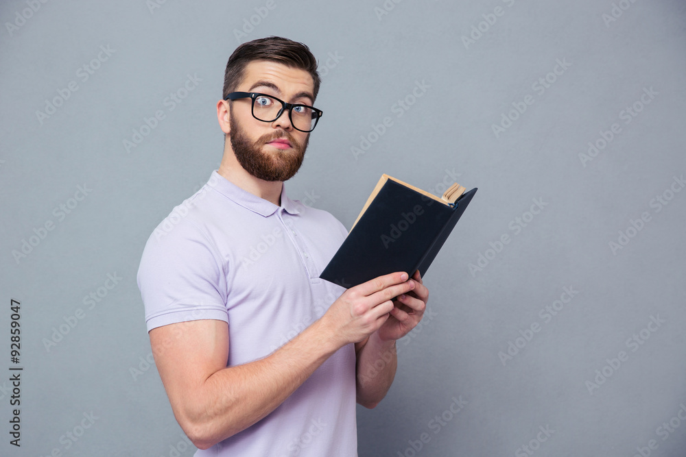 Portrait of a serious hipster man holding book Portrait of a serious hipster man holding book