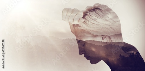 Φωτογραφία Composite image of sad blonde woman with her head on wall