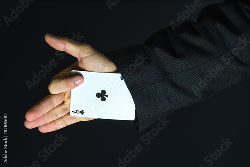 Photography Man with ace up his sleeve on black background