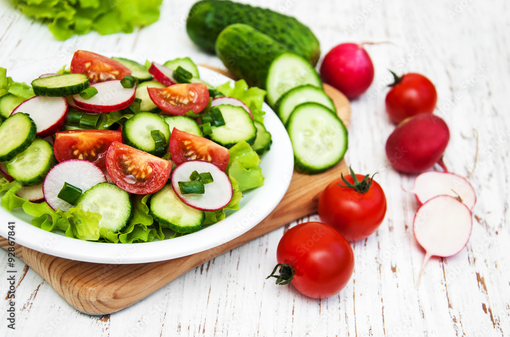 Spring salad with tomato, cucumbers and radish Spring salad with tomato, cucumbers and radish