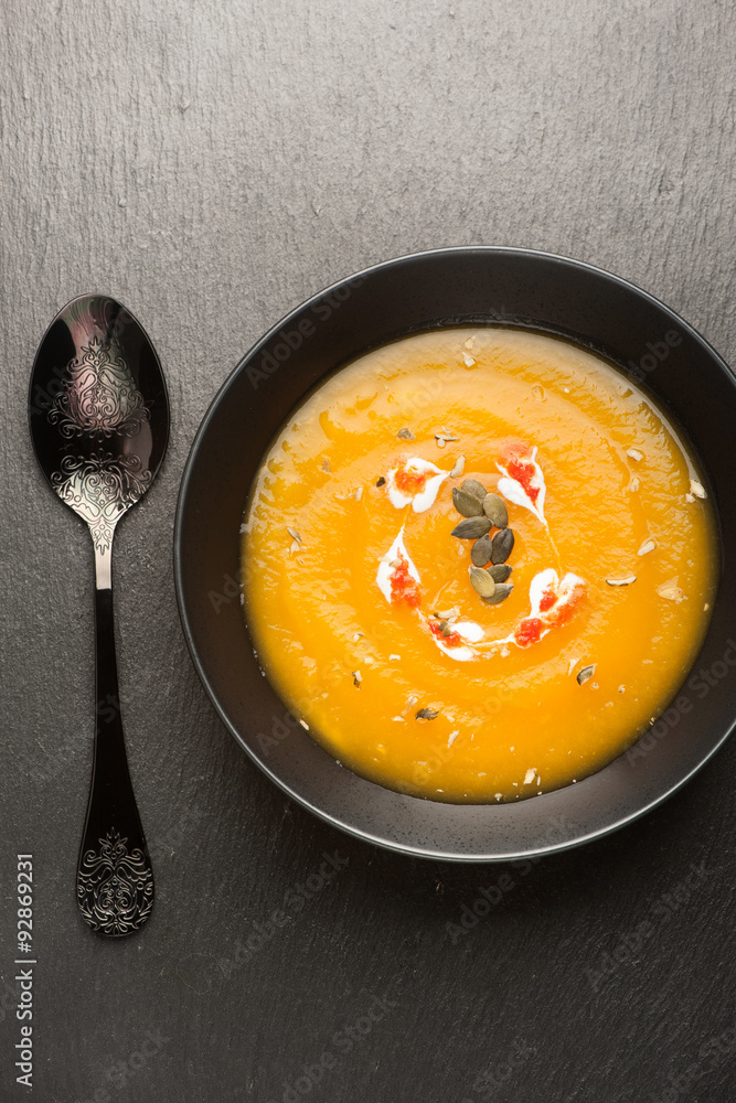 Pumpkin soup on a black background, vertical Pumpkin soup on a black background, vertical