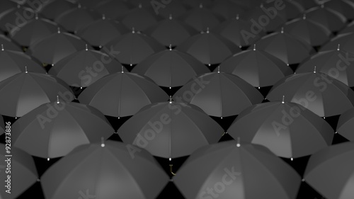 Classic large black umbrellas tops background  focus on center.