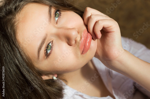 Canvas Print Closeup of charming girl pouting lips and looking up melancholy
