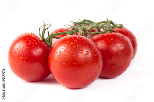 Bunch of fresh tomatoes with water drops. Isolated