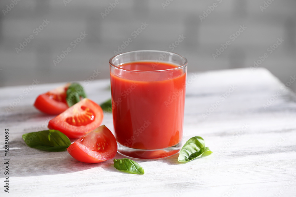 Tomato juice and fresh tomatoes on wooden table close-up Tomato juice and fresh tomatoes on wooden table close-up