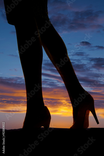silhouette of  womans legs side walk