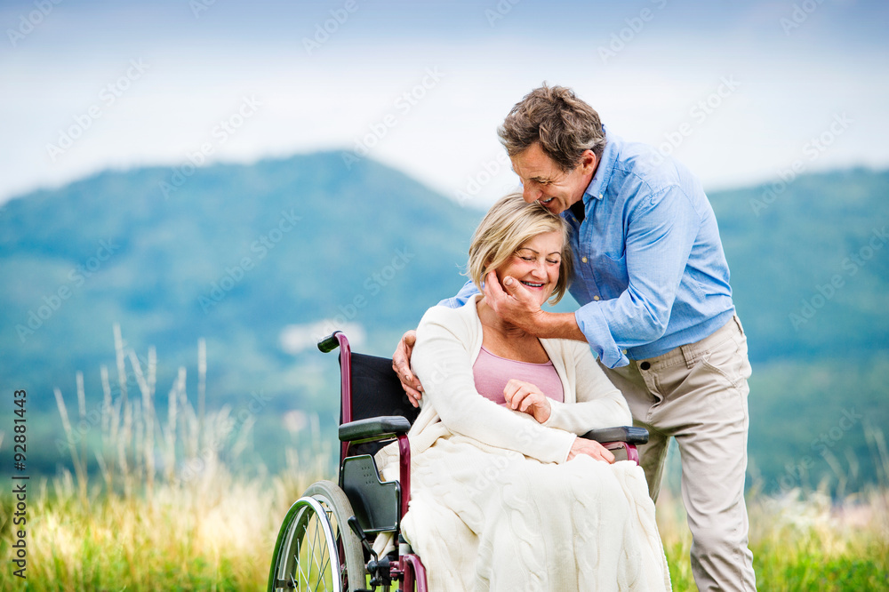 Man with woman in wheelchair