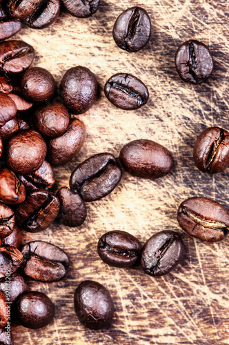 Coffee beans on grunge wooden background