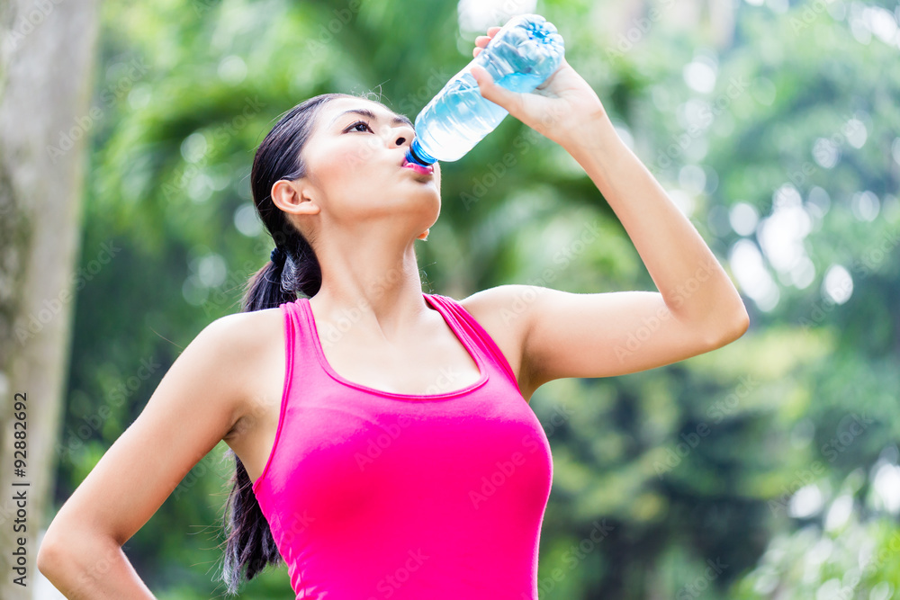 Asian woman having break from sport training Asian woman having break from sport training
