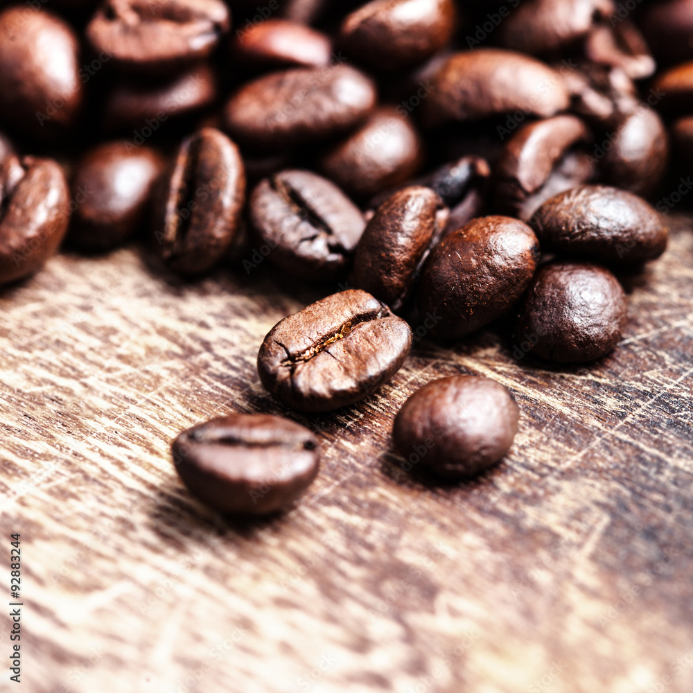 Coffee beans on grunge wooden table top view image, macro Coffee beans on grunge wooden table top view image, macro