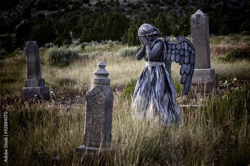 Obraz na plátně Girl wearing an angel costume in an old grave yard