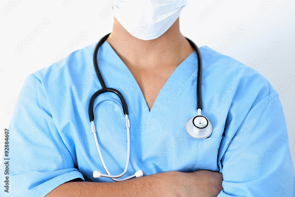Portrait of unknown male surgeon doctor holding his stethoscope, crossed arms Portrait of unknown male surgeon doctor holding his stethoscope, crossed arms