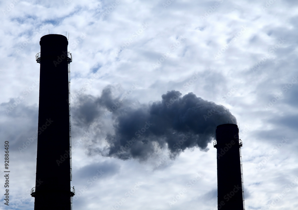 Smoke from smokestack of industrial factory pollutes air 