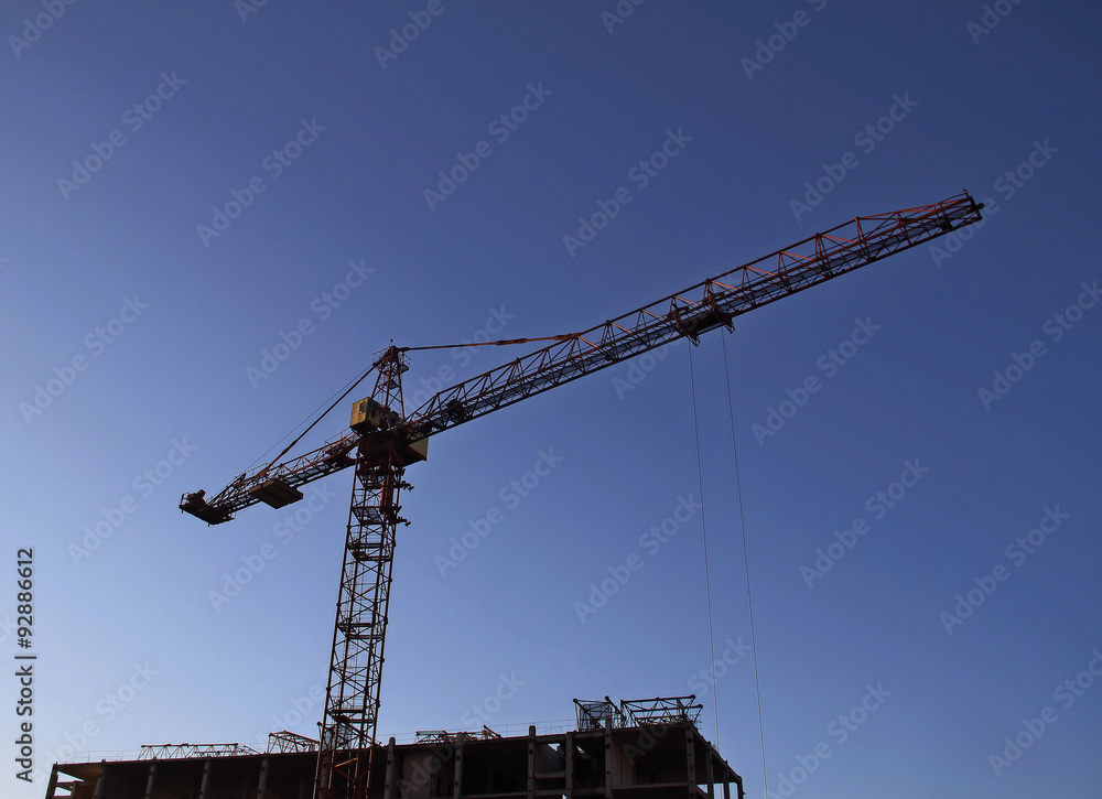 Construction crane over concrete frame of high rise building Construction crane over concrete frame of high rise building