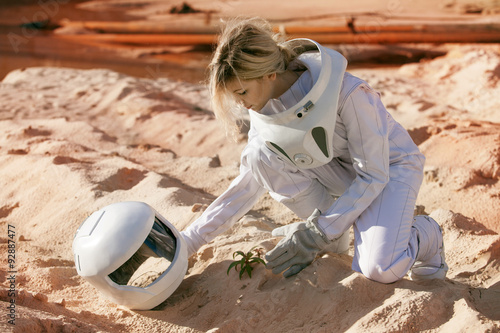 Grow plants on Mars, futuristic astronaut without a helmet