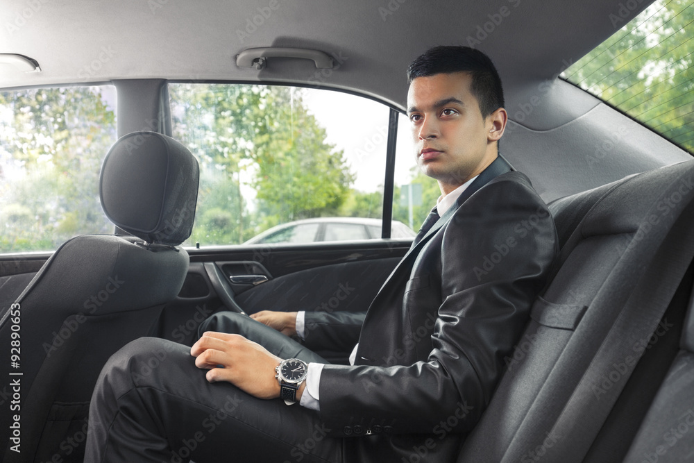 Young businessman traveling to work by taxi