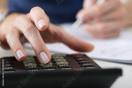 Close up of female accountant or banker making calculations