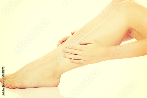 Woman massaging her leg