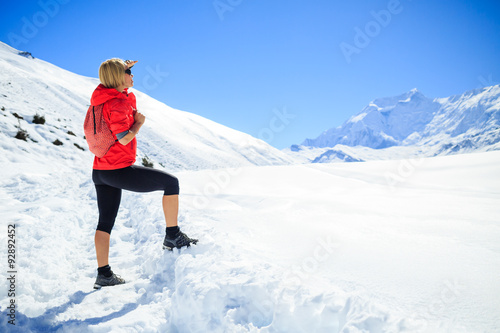 Woman hiking in winter mountains