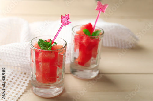 Wallpaper Mural Cold watermelon pieces in glasses, on wooden table background Torontodigital.ca