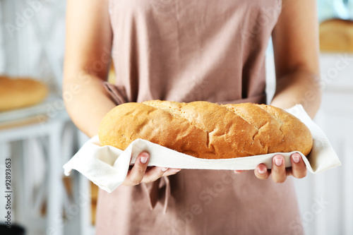 Wallpaper Mural Baker holding freshly baked bread in kitchen of bakery Torontodigital.ca