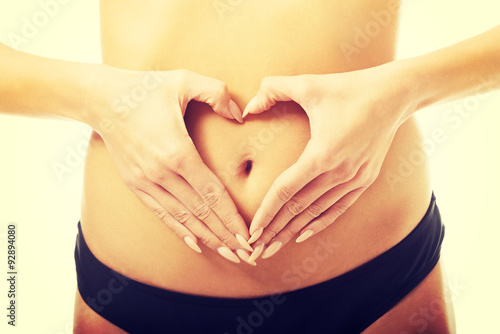 Wallpaper Mural Woman making heart shape on belly  Torontodigital.ca