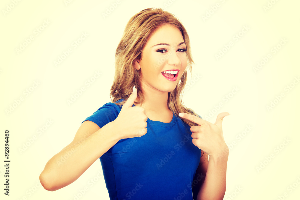 Fototapeta premium Young happy woman with thumbs up.