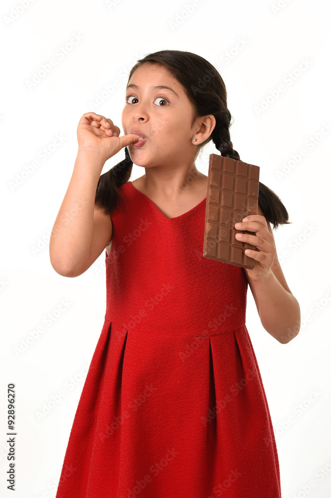 female child holding chocolate eating in happy excited face expression in sugary nutrition