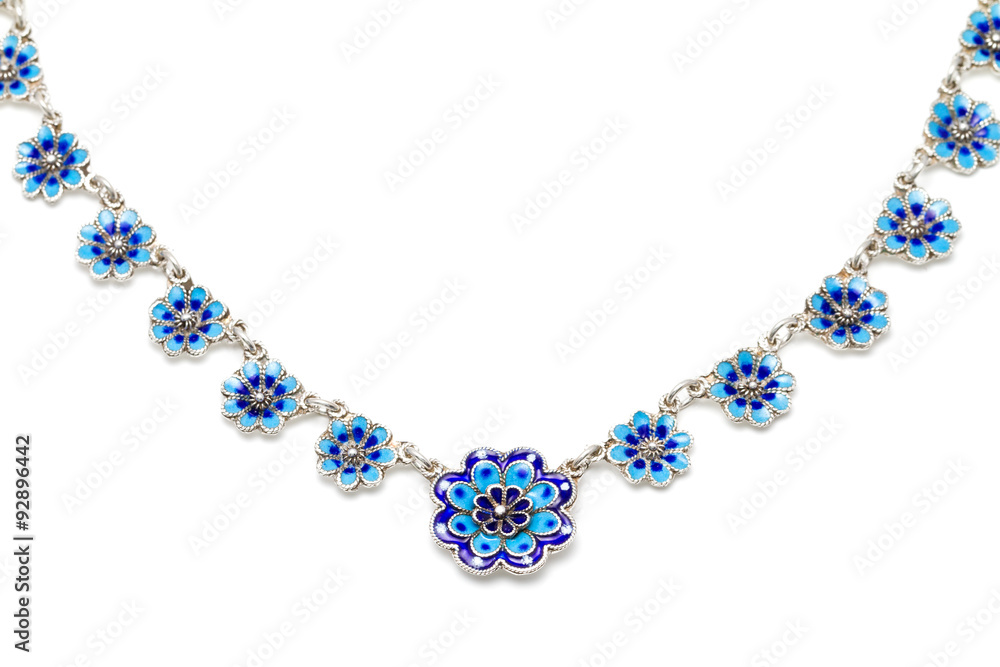 Antique silver, blue vitreous enamel necklace in the shape of little flowers against a white background Antique silver, blue vitreous enamel necklace in the shape of little flowers against a white background