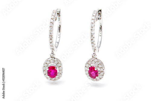 With gold earrings with pink stones and diamonds