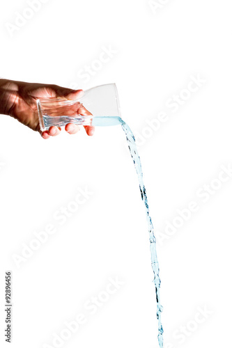 Man holding a glass with blue water flowing out on a white background