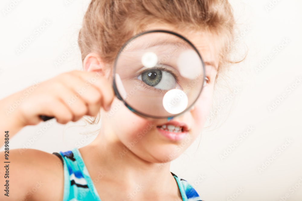 Little girl kid looking through magnifying glass. Little girl kid looking through magnifying glass.
