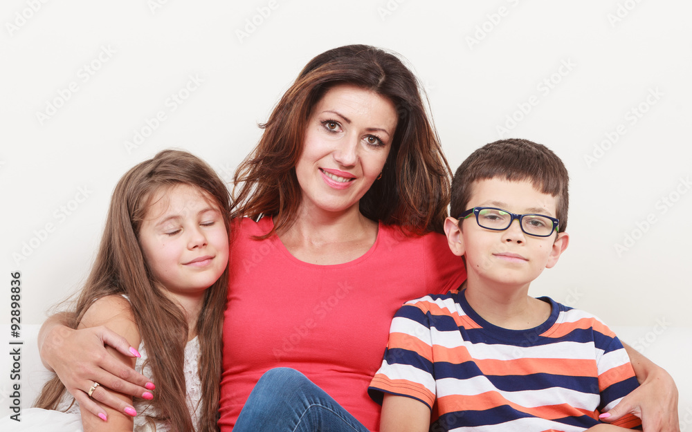 Obraz premium Happy family. Mother and kids on sofa at home.