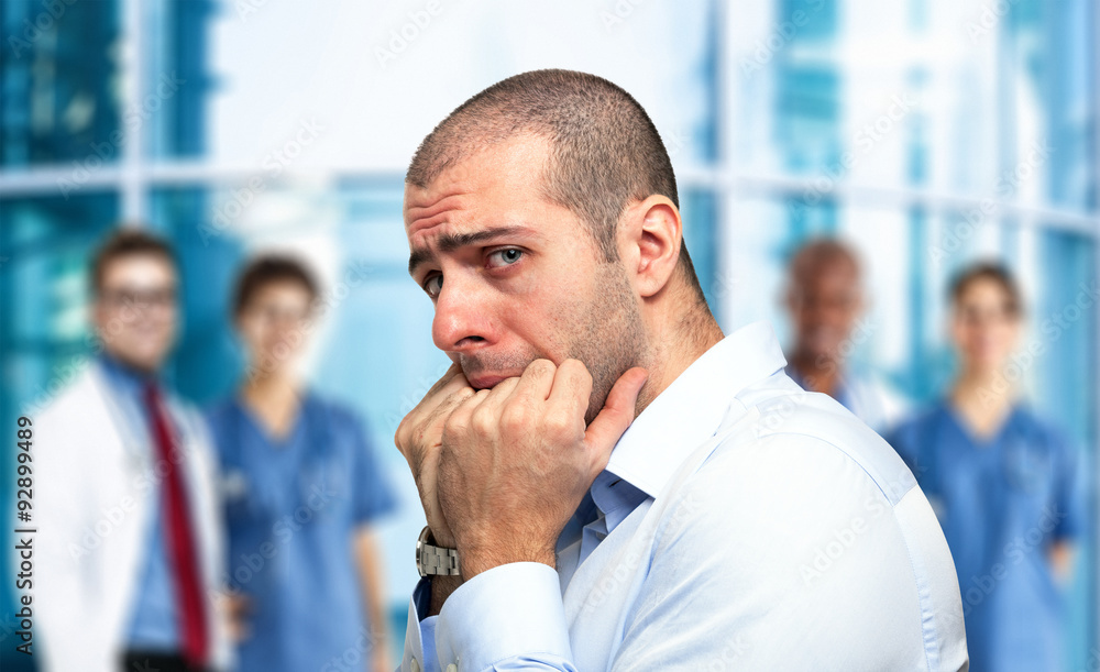 Scared guy in front of an hospital Scared guy in front of an hospital