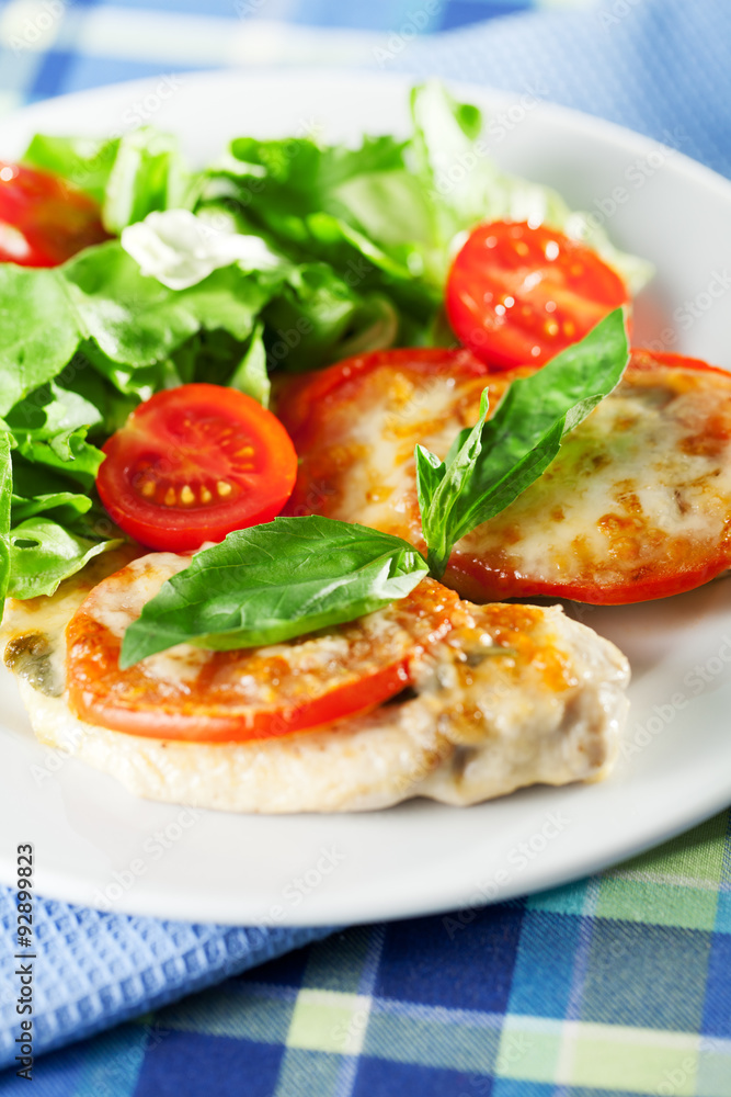 Chicken baked with mozzarella and tomatos