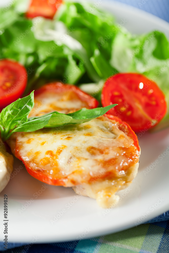 Chicken baked with mozzarella and tomatos