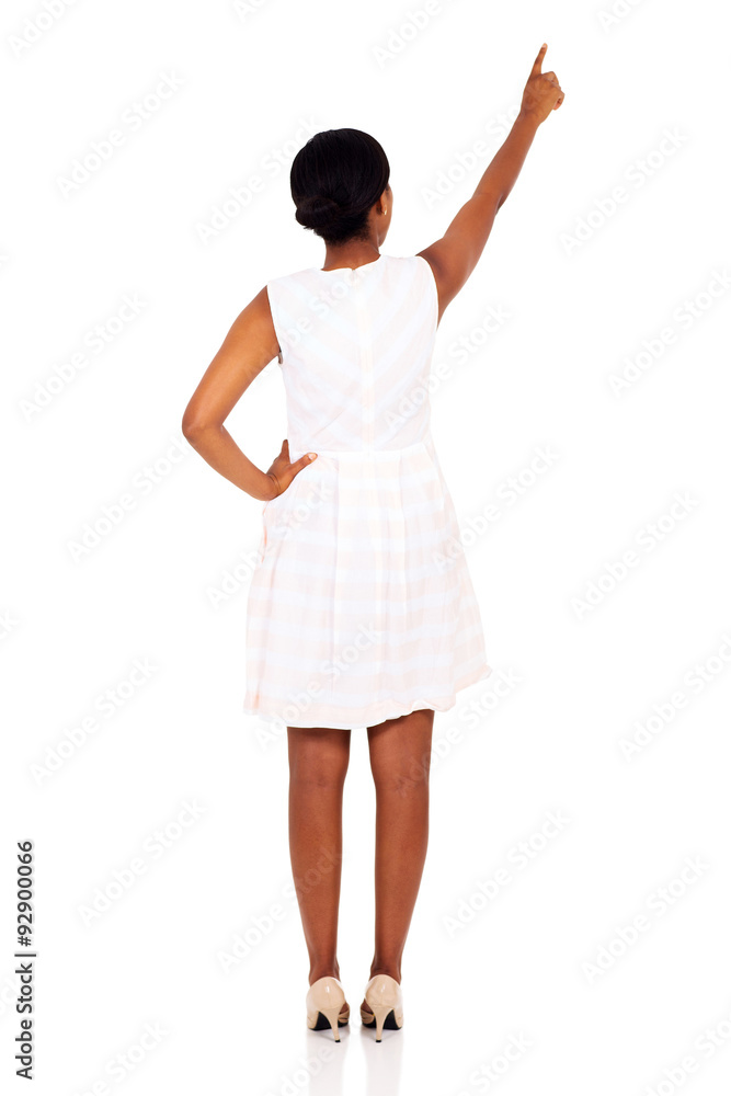 rear view of african woman pointing empty copy space rear view of african woman pointing empty copy space