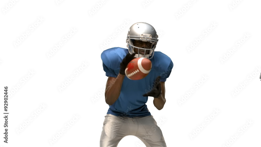 Serious american football player tackling for ball Serious american football player tackling for ball