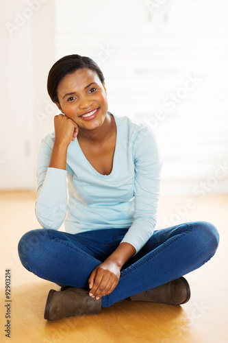 african american woman sitting on floor in new house