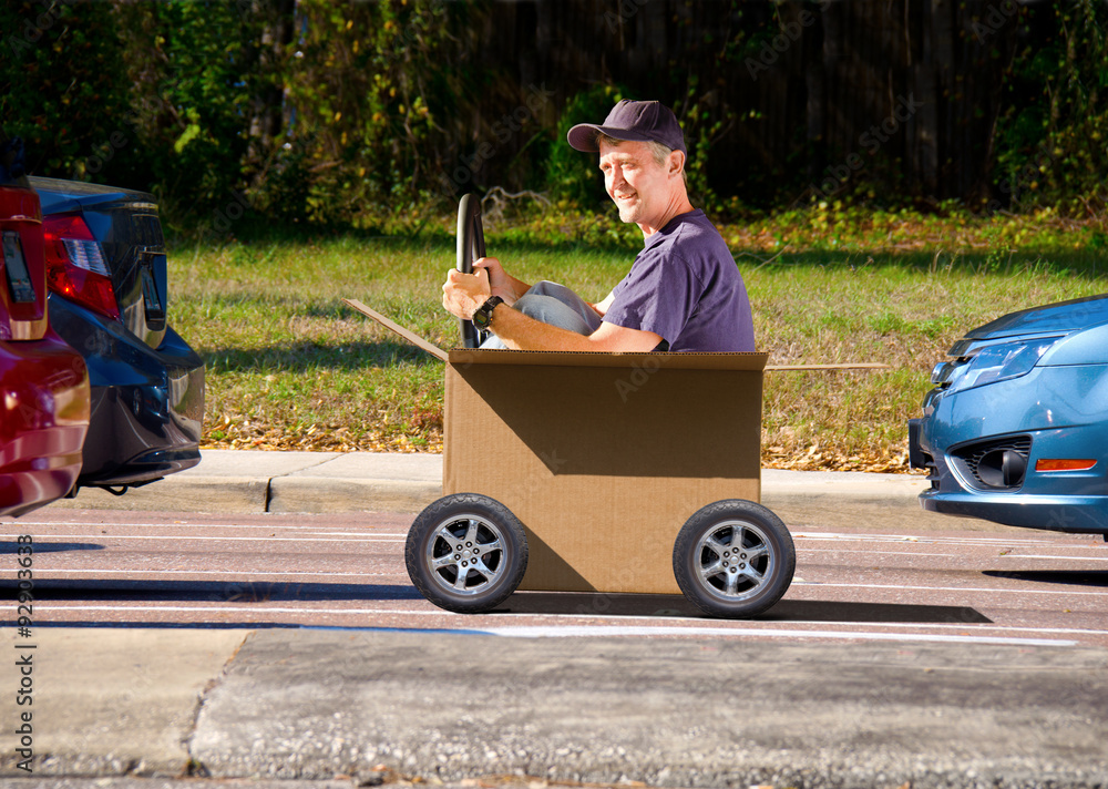 A man is driving a box in traffic on moving day, illustrating a fun ...