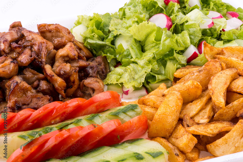 Fototapeta premium fried chicken with salad and potatoes - close up