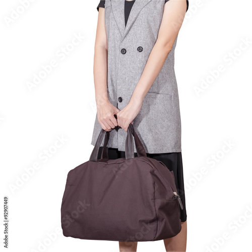 women hand hold the travel bag, brown color on white background,