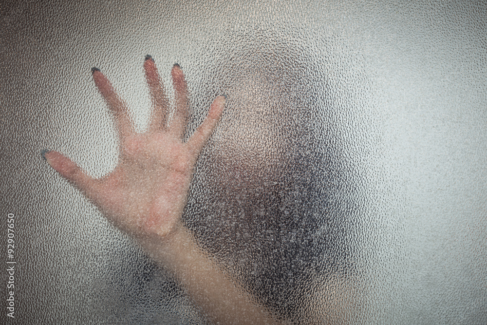 Obraz premium Halloween female hand behind transparent glass background as sil